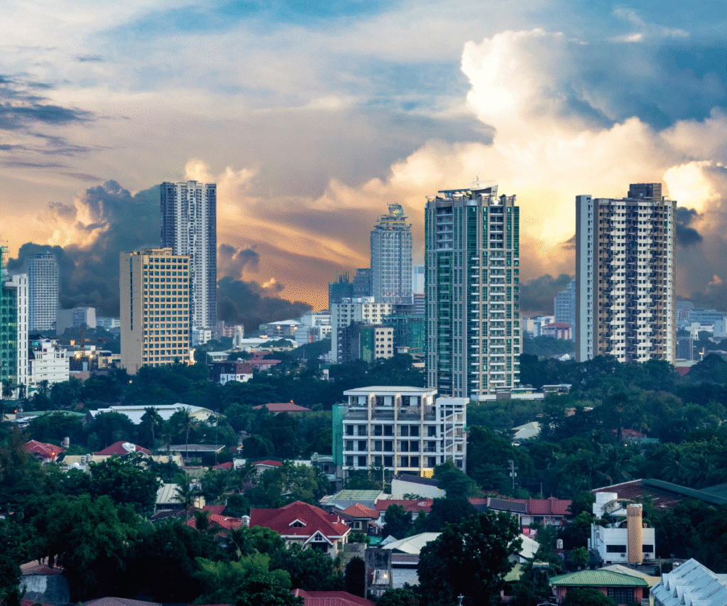 Cebu City skyline at sunset with high-rise buildings and dramatic clouds