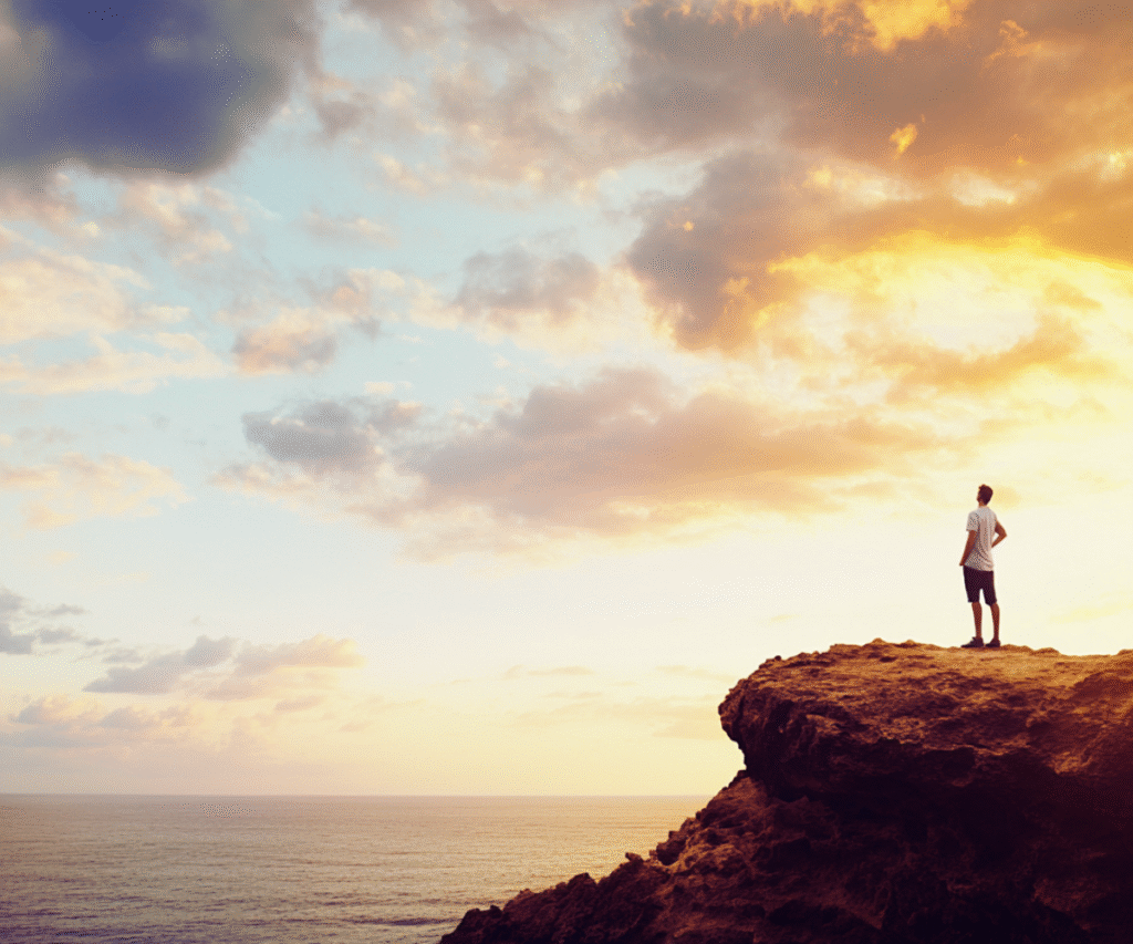 digital-nomad-freedom-sunrise-cliff Freedom and adventure as a digital nomad — man standing on a cliff at sunrise