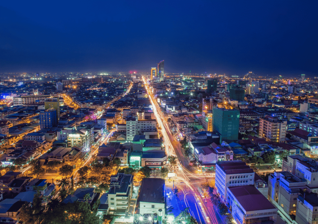 Phnom Penh city skyline at night with bright street lights and high-rise buildings